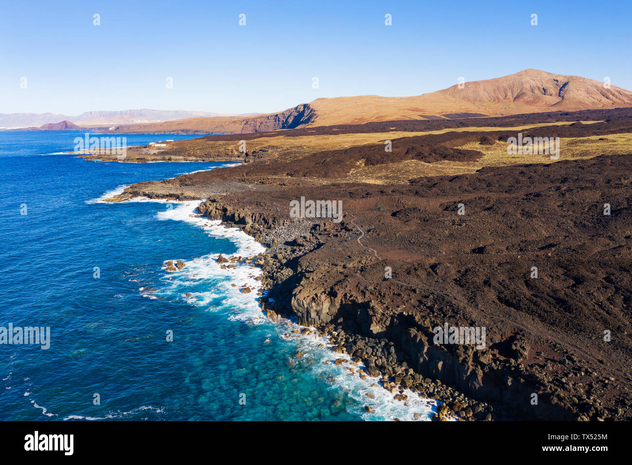 Spain, Canary Islands, Lanzarote, Tinajo, Los Volcanos nature park, aerial view over rocky coast Stock Photo