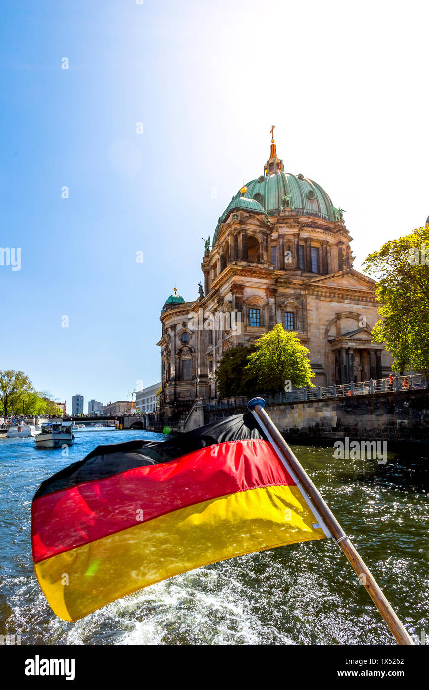 Germany, Berlin, Berlin Cathedral and German flag on excursion boat on River Spree Stock Photo