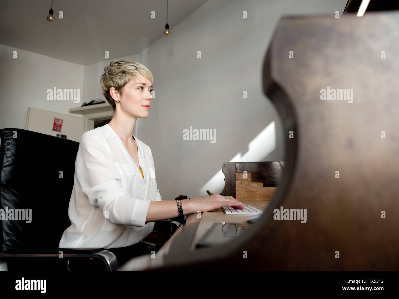 Blond woman working at home office Stock Photo