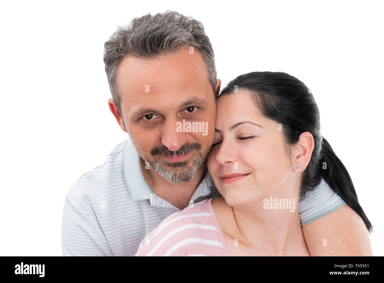 Closeup portrait of smiling man and woman couple hugging as cute relationship concept isolated on white studio background Stock Photo