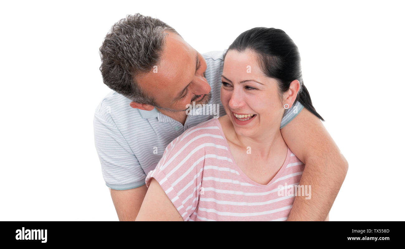 Closeup of man and woman couple hugging and looking at each other as cute relationship concept isolated on white background Stock Photo