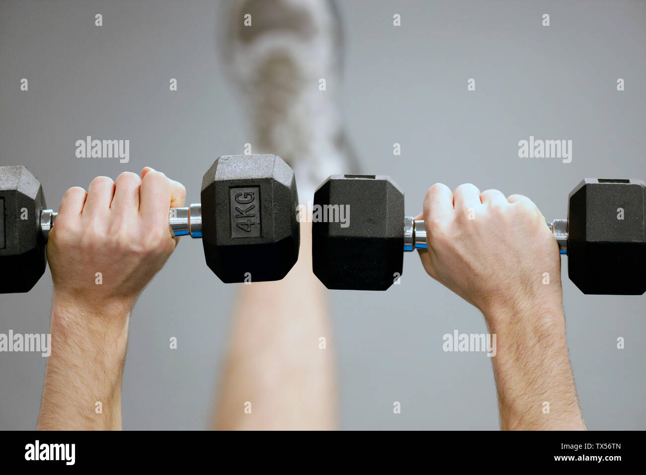 Man lifting weights in gym Stock Photo