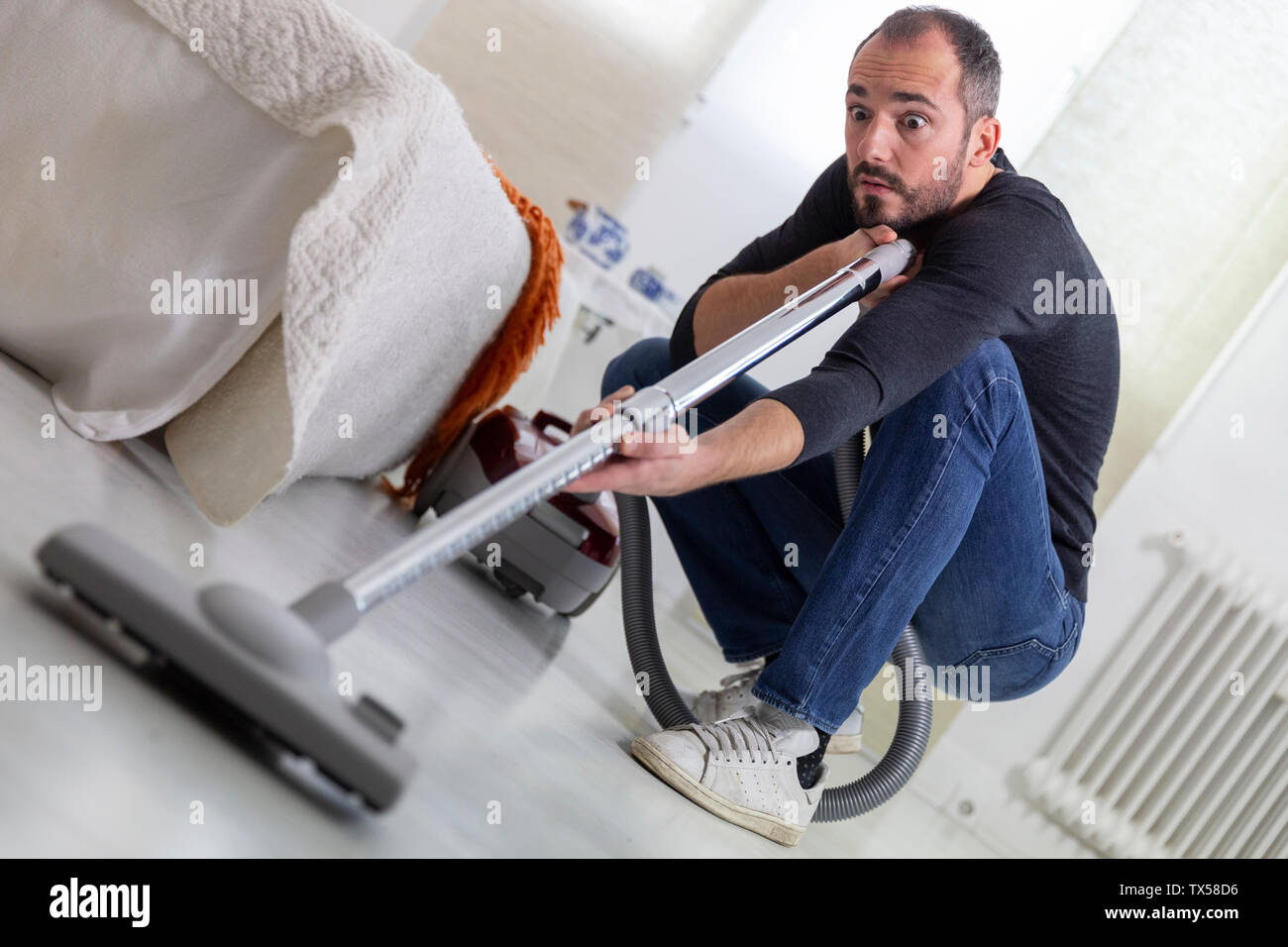 A man vacuuming. Stock Photo