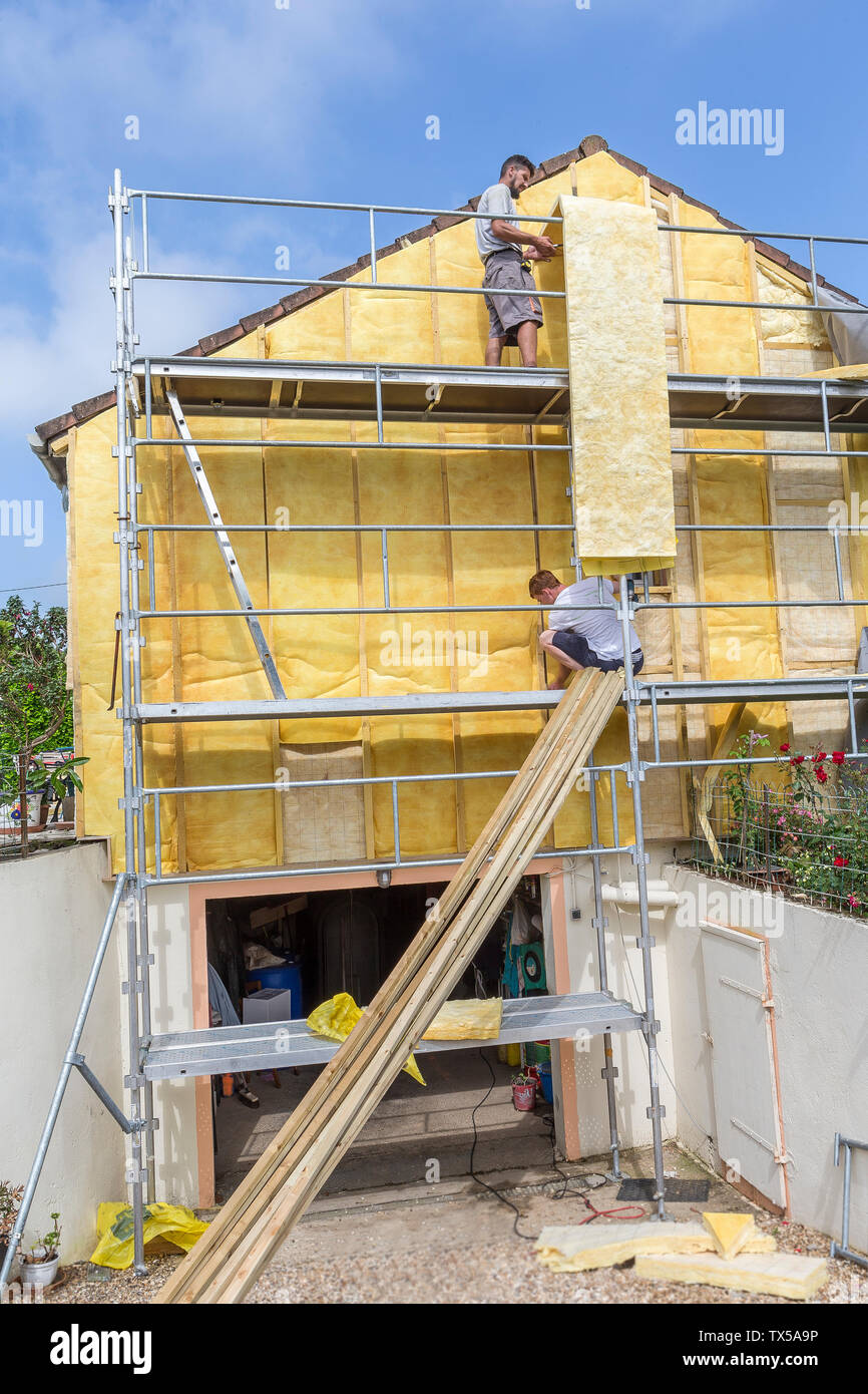 House insulation. scaffolding,mineral wool, cladding of buildings, resource conservation, Stock Photo