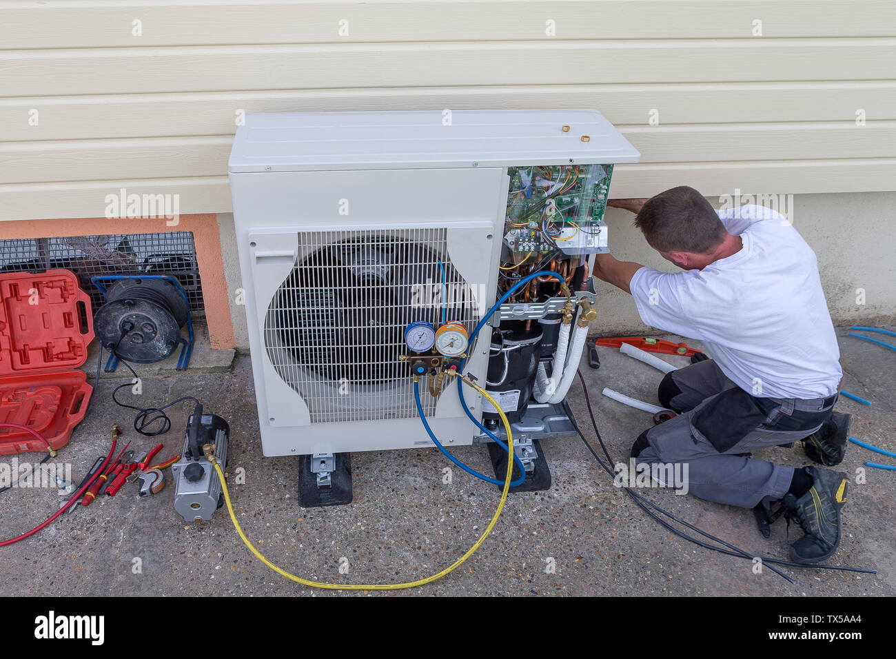 Heat Pump. plumber at work installing a circulation pump Stock Photo