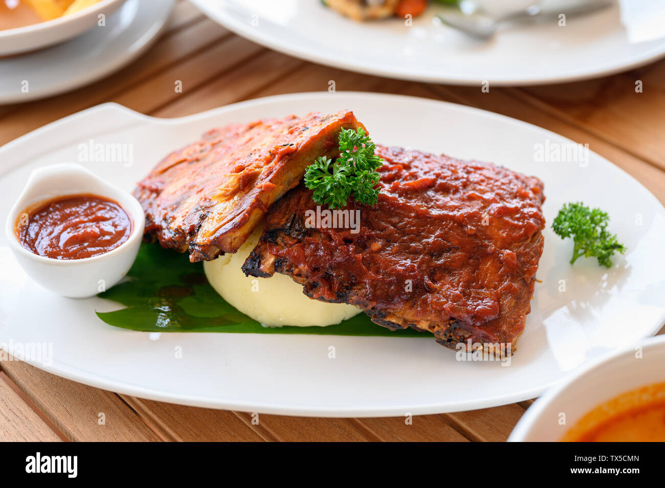 Grilled ribs pork with barbeque sauce on white plate Stock Photo