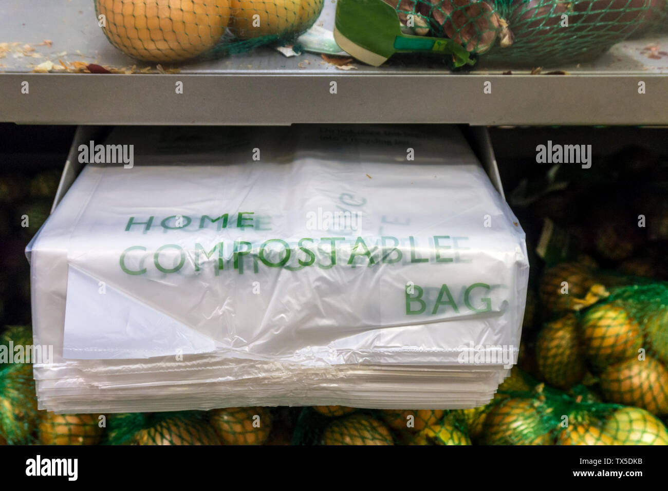 Waitrose supermarkets are replacing the loose plastic bags in their fruit and vegetable sections with compostable bags that can be used as liners for food waste caddies or put in home compost bins.  They expect this to save the use of 71m plastic bags a year. Stock Photo