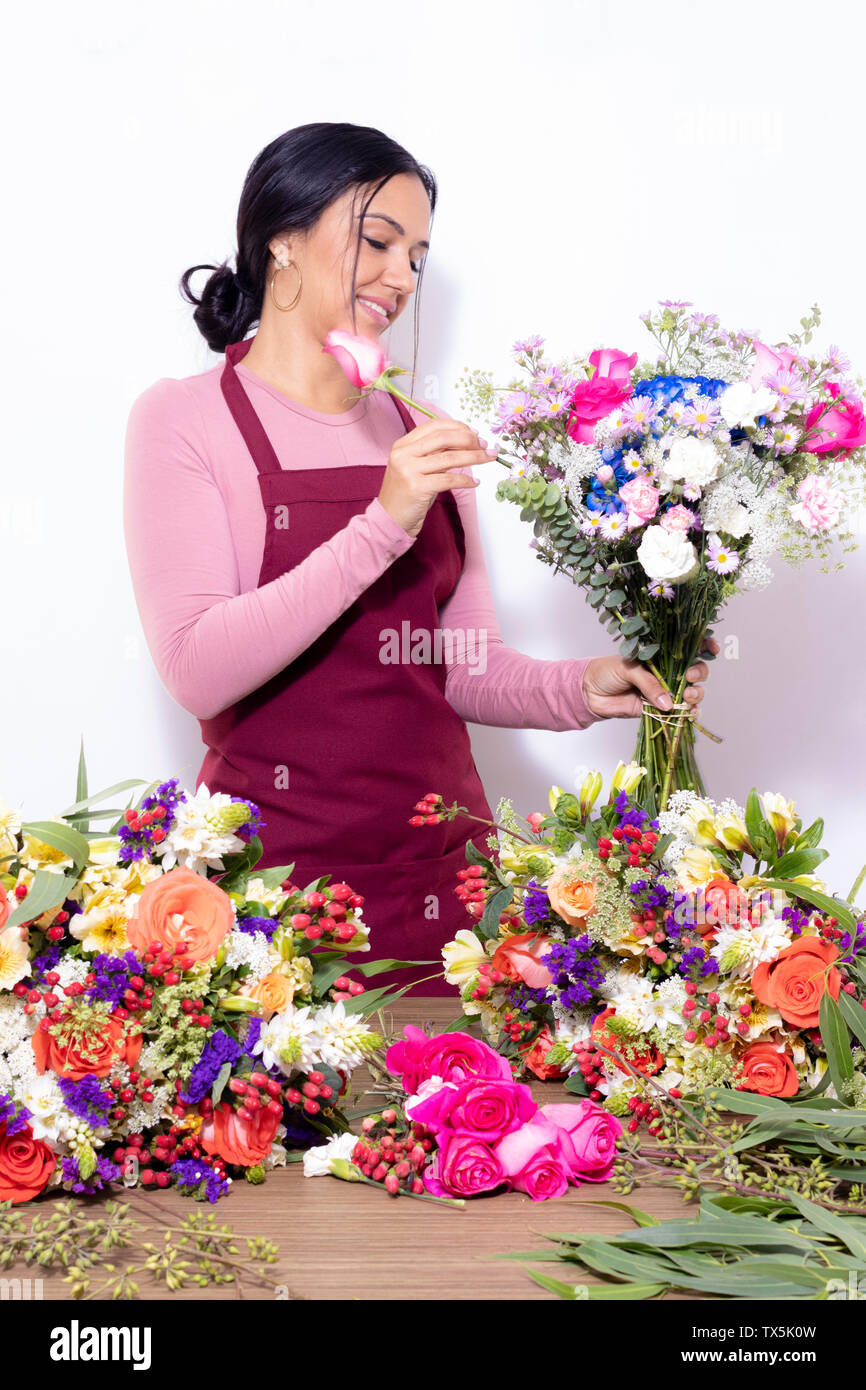 Brunette woman making bouquets at the florist shop Stock Photo