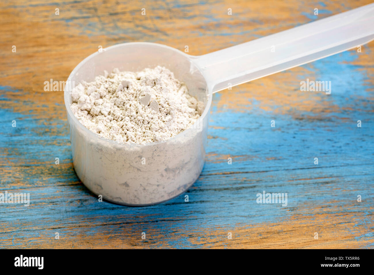 food grade diatomaceous earth supplement scoop of powder Stock Photo