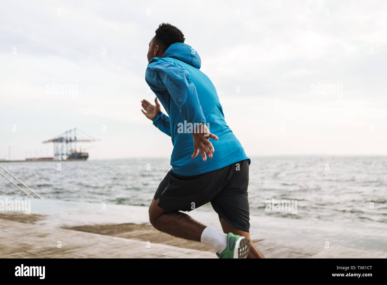 Photo of a strong handsome young african sports man runner outdoors at ...