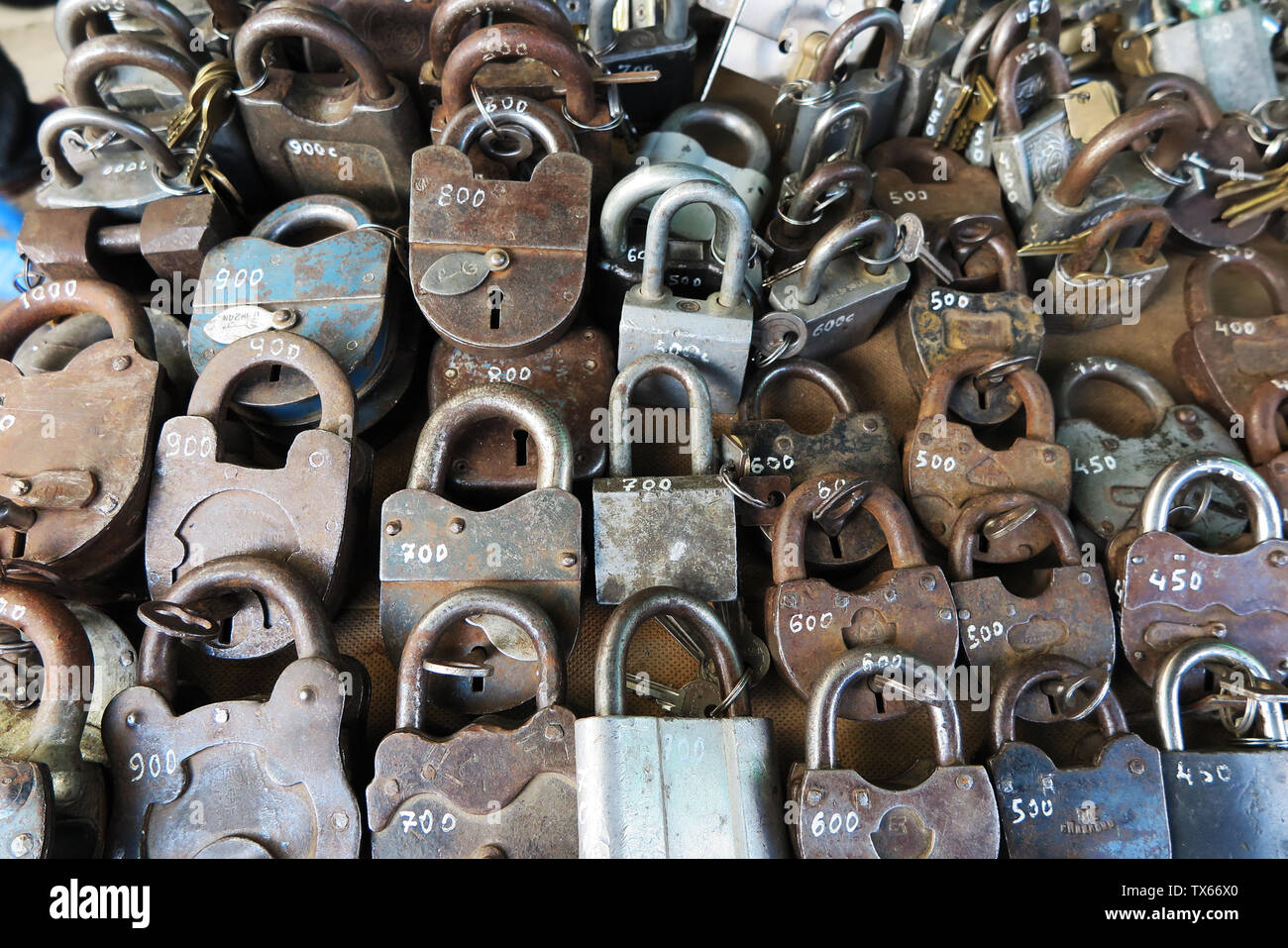 A couple of old padlocks in Karakol town market. Price in local money. Stock Photo