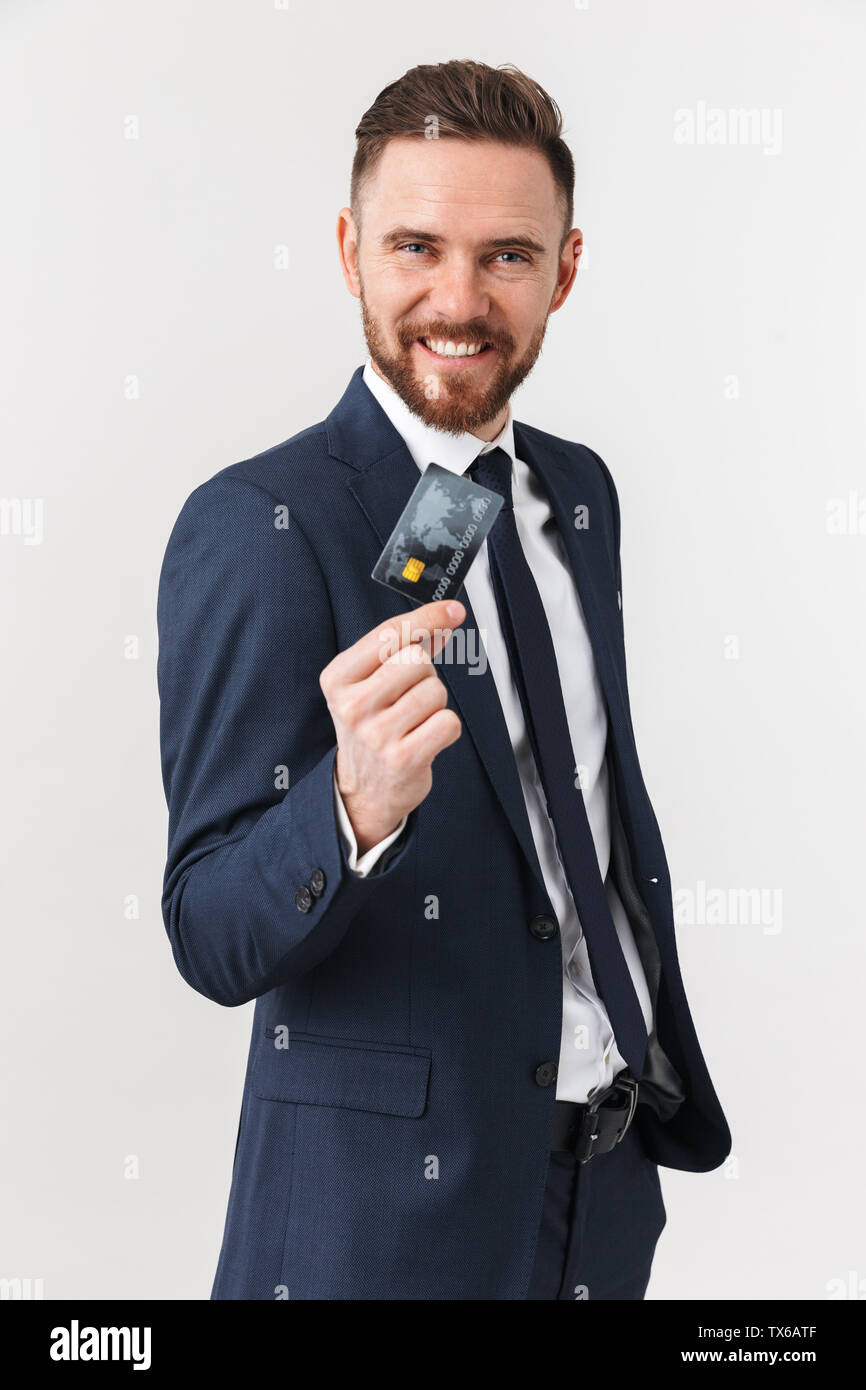 Image of happy young businessman posing isolated over white wall ...