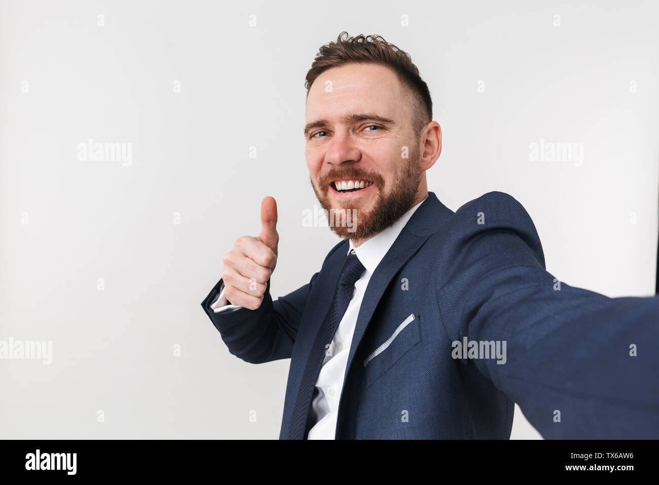 Image of a happy young handsome businessman posing isolated over white ...