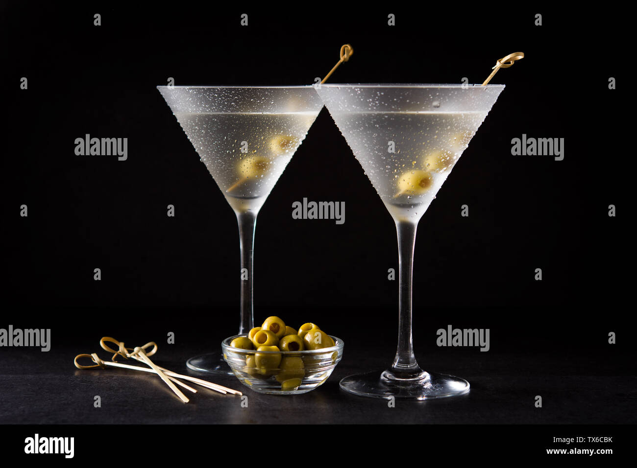 Classic Dry Martini with olives on black background Stock Photo Alamy