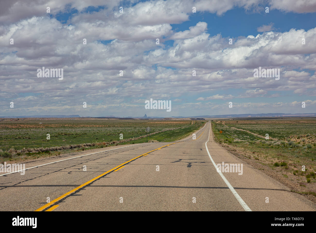 Scenic long highway, cloudy blue sky. Monument Valley Navajo Tribal Park in the Arizona-Utah border, USA Stock Photo