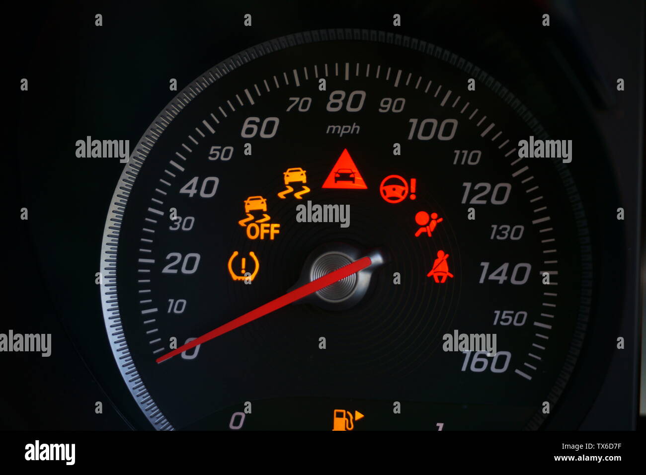 Speedometer with warning lights illuminated Stock Photo