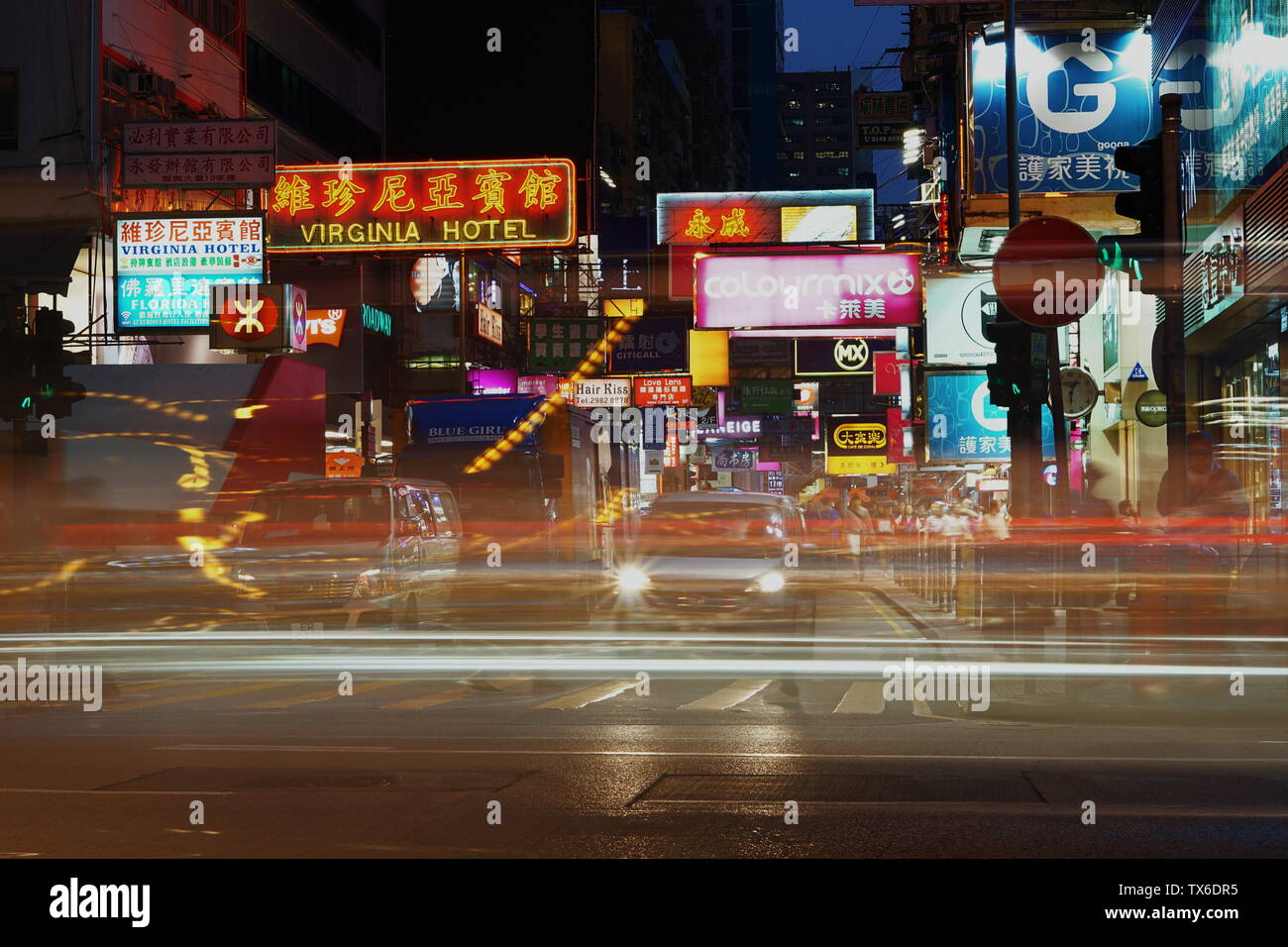 Long exposure image of cars passing a junction in Mong Kok, Hong Kong Stock Photo