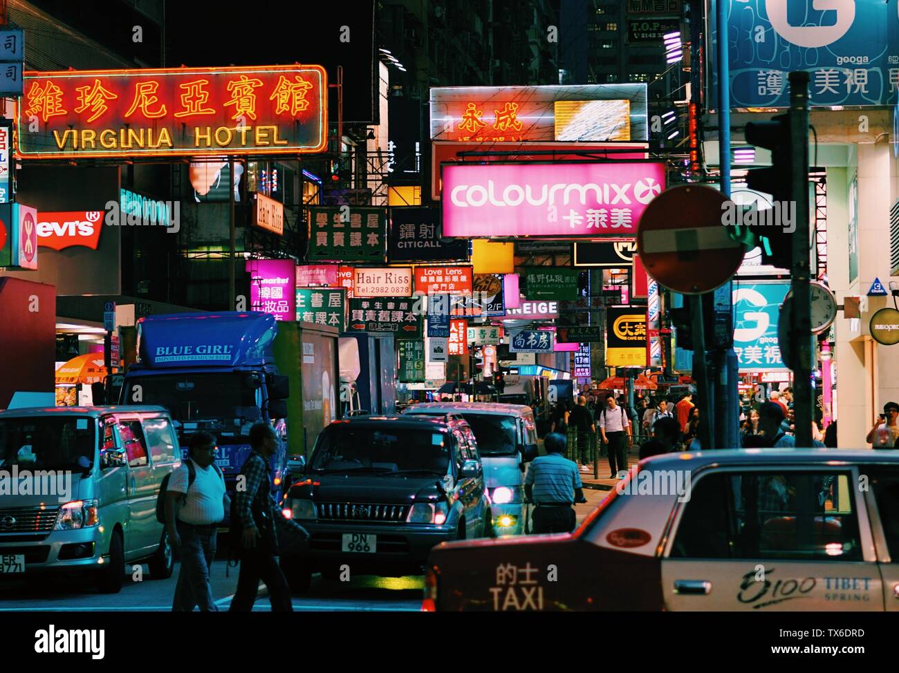 Light signs above traffic at junction in Mong Kok, Hong Kong Stock Photo