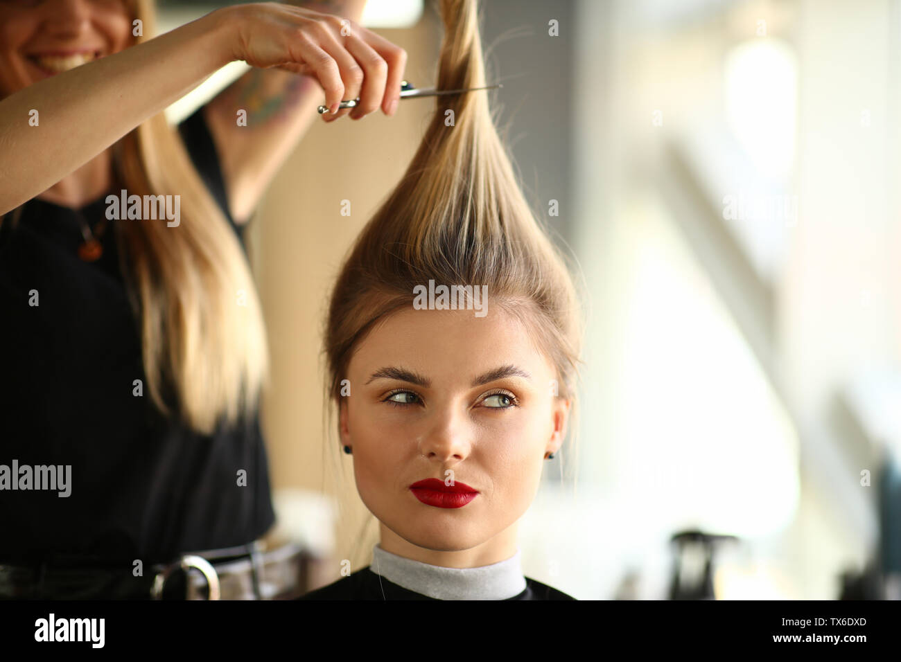 Young Woman With Ponytail Getting Haircut In Salon Hairdresser
