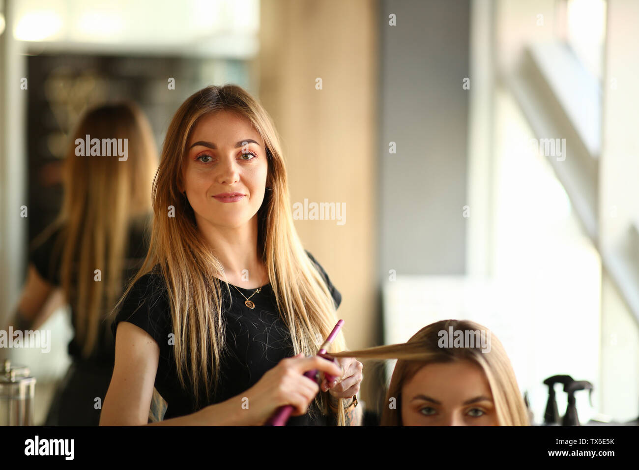Young Hairstylist Making Curls For Girl Client Woman Hairdresser