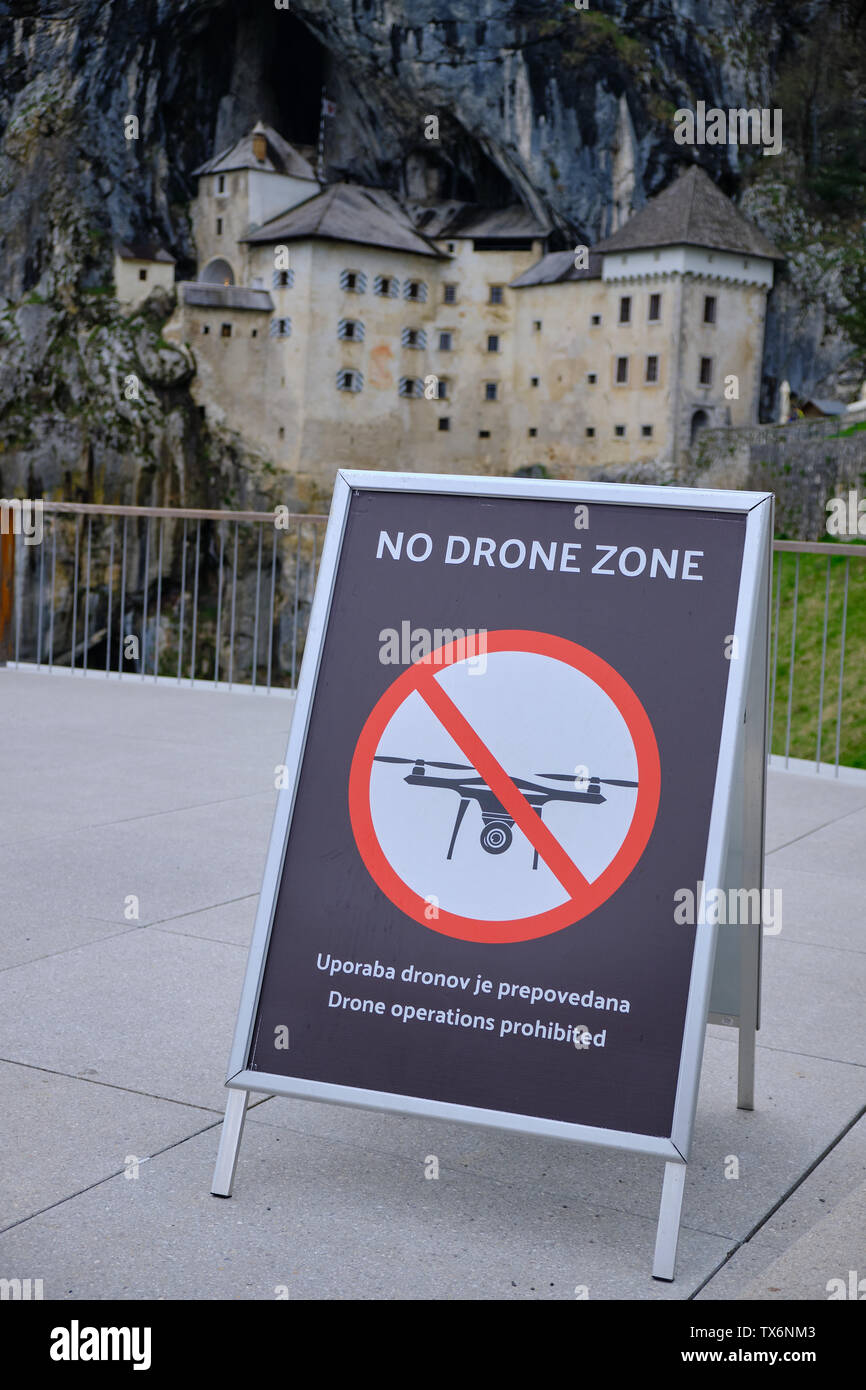 No drone zone allowed sign in front of Predjama Castle. Predjama, Slovenia, April 2019 Stock Photo
