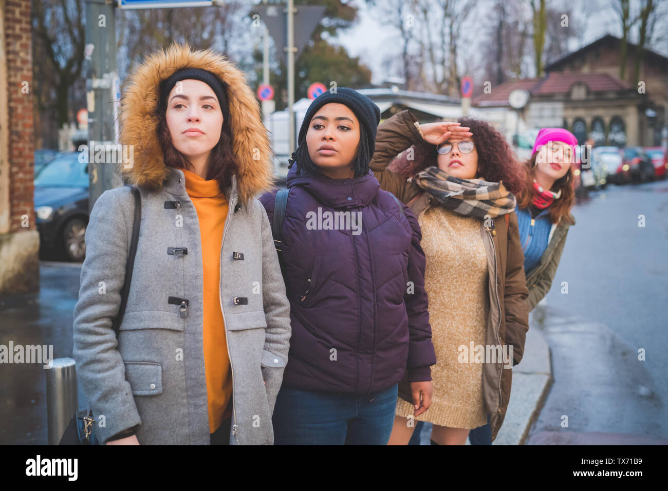 group of young women standing in the street and looking ahead – friendship, multiracial, await Stock Photo