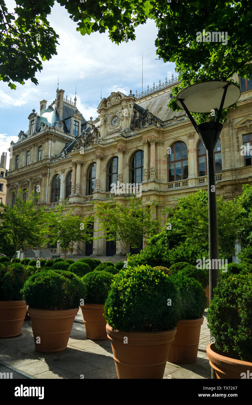 Bourse palace (Stock Exchange building) in Lyon surrounded by green leaves. Stock Photo