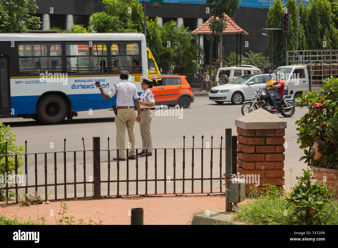 Bangalore, Karnataka India-June 04 2019 :Moving Traffic near town hall circle and City traffic police busy at work in Bengalore Stock Photo