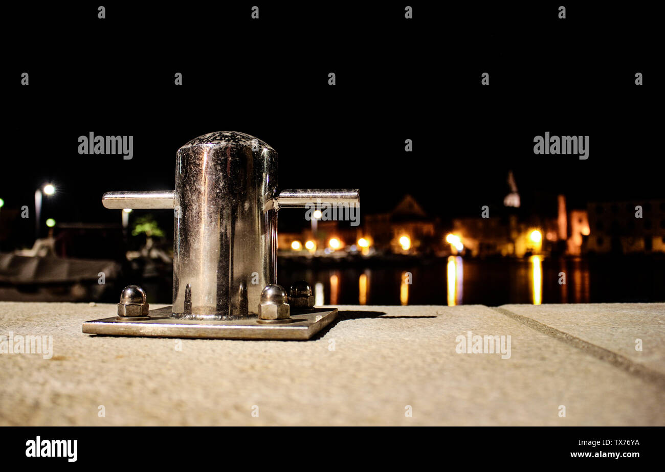 Silver or nickel mooring post closeup on marina end Stock Photo