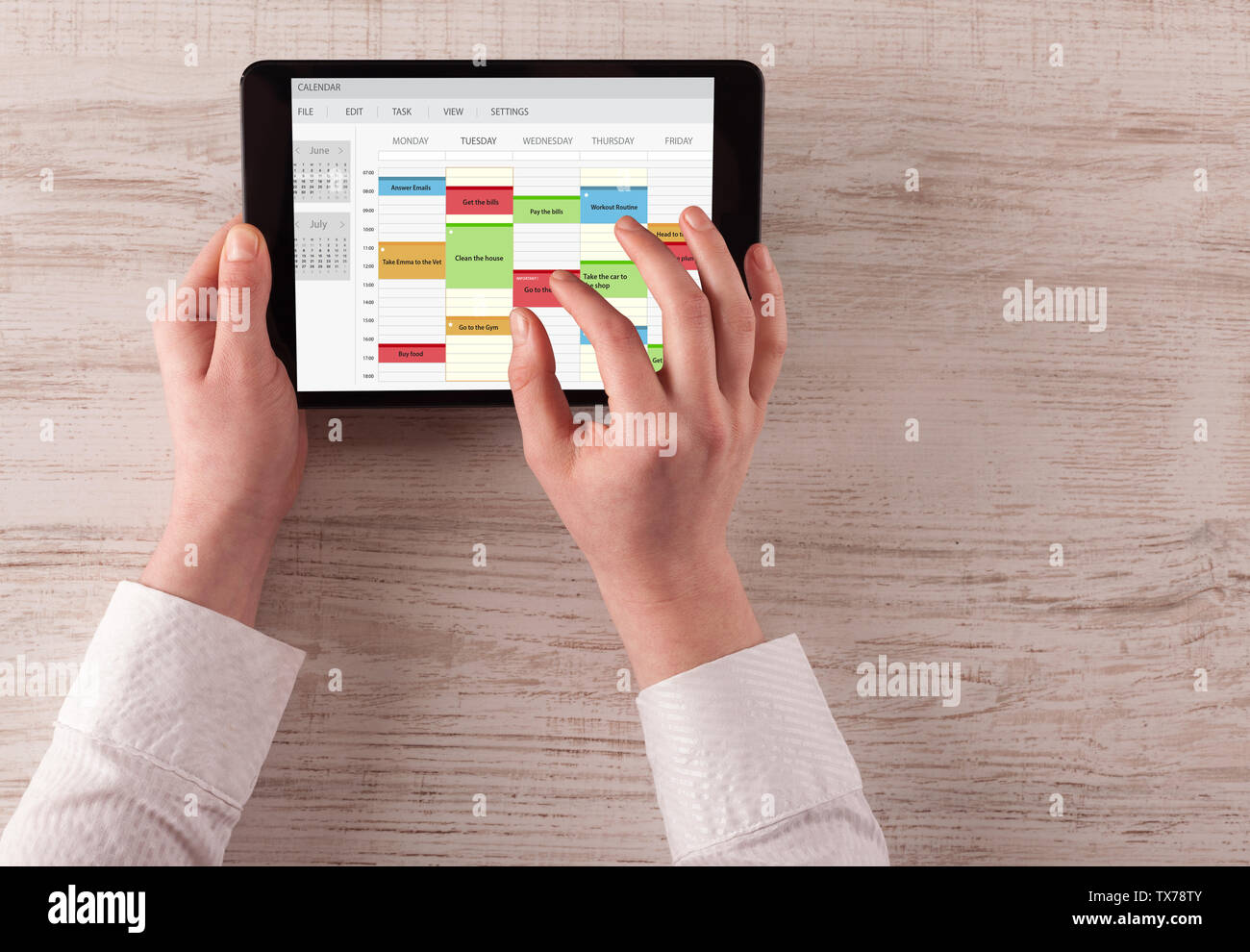 Hand holding tablet with timetable and calendar concept Stock Photo - Alamy