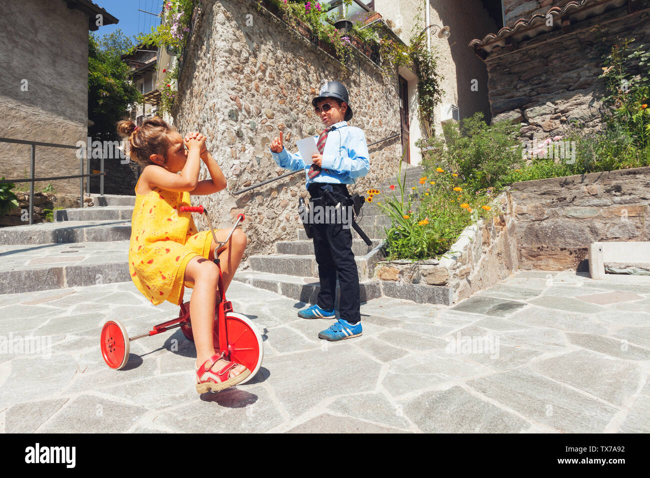 Scene with children playing, cop and driver Stock Photo