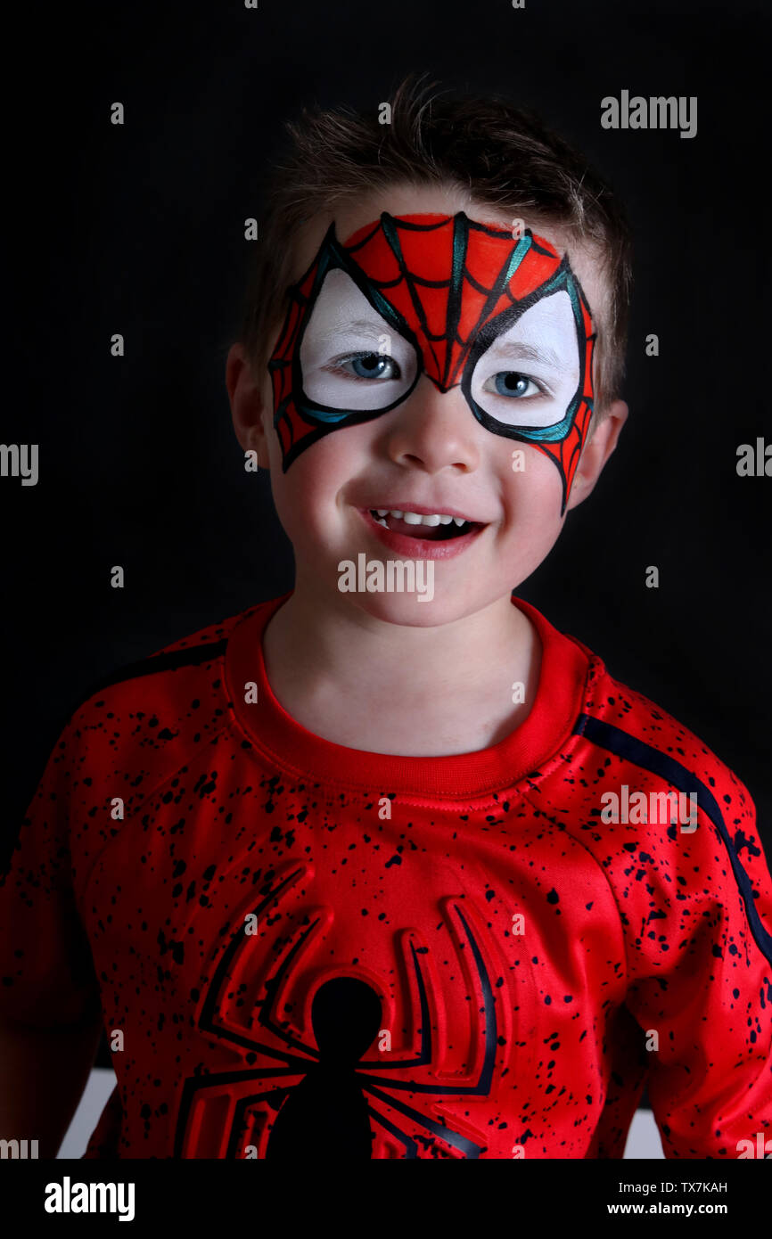 toddler boy with spider-man face paint smiling Stock Photo