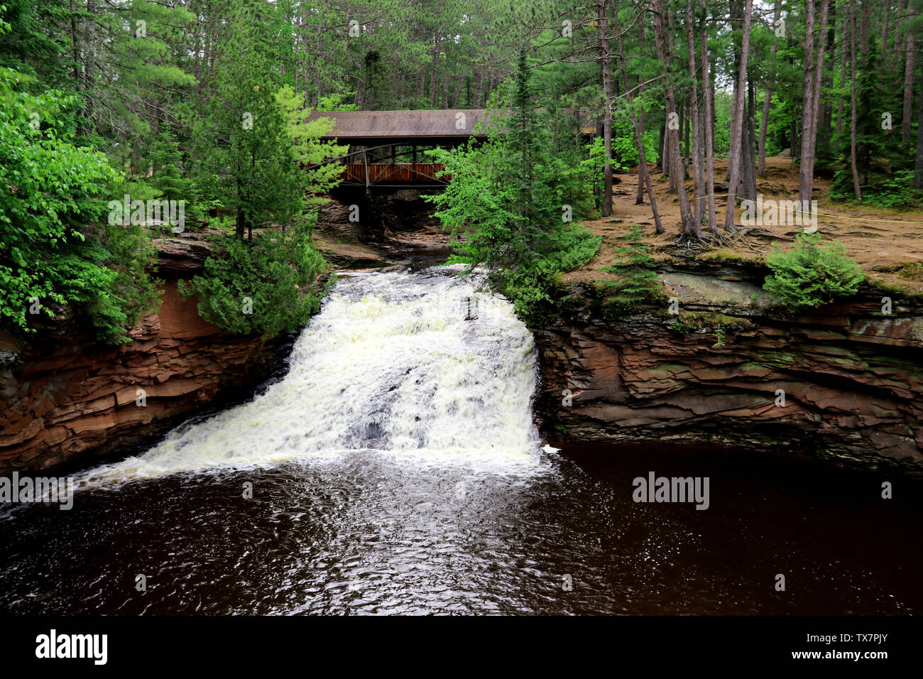 Covered bridge and Waterfall at Amnicon Falls State Park in Wisconsin Stock Photo