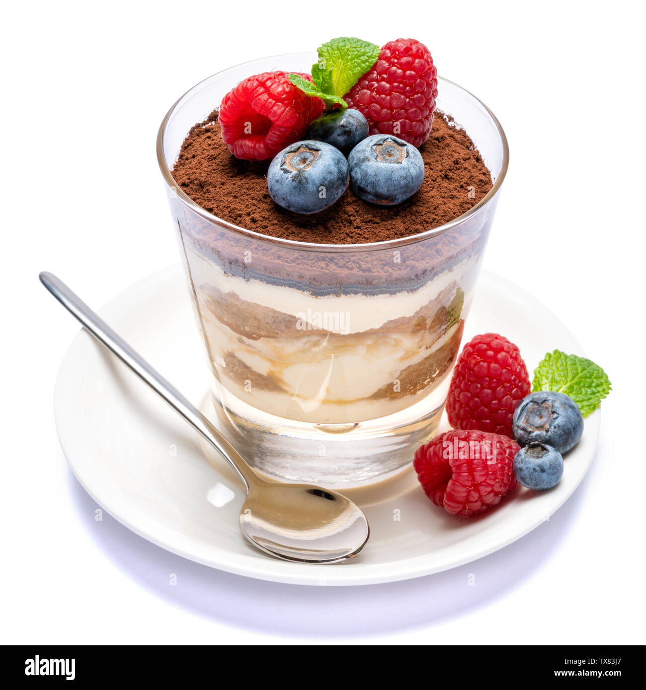 Classic tiramisu dessert with blueberries and raspberries in a glass ...