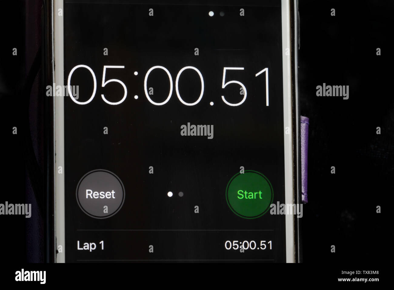 Stop clock on a smart phone showing the time at 5 minutes Stock Photo