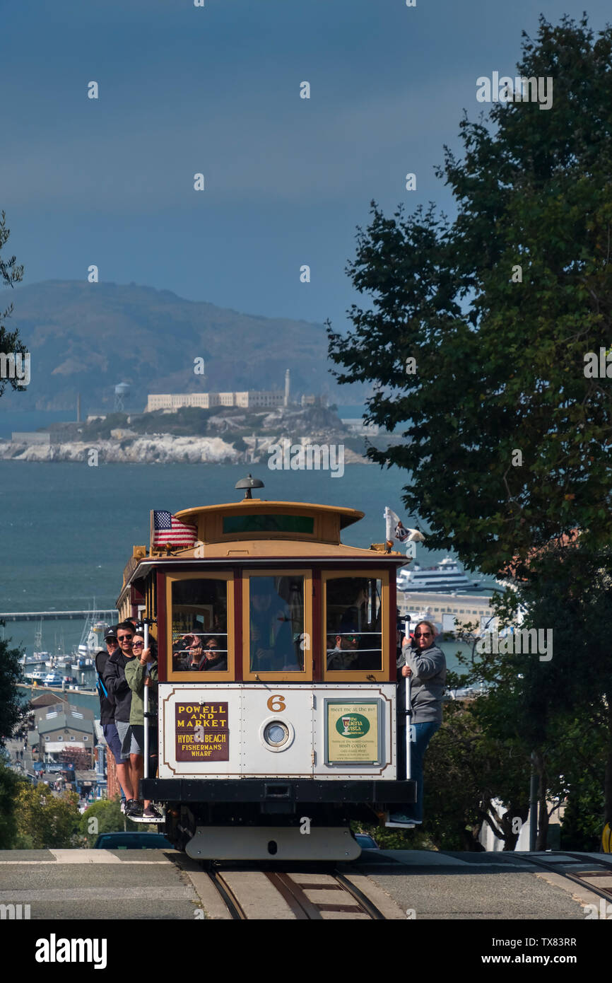 The Powell and Market Cable Car on Hyde Street, backed by Alcatraz, San Francisco, California, USA Stock Photo
