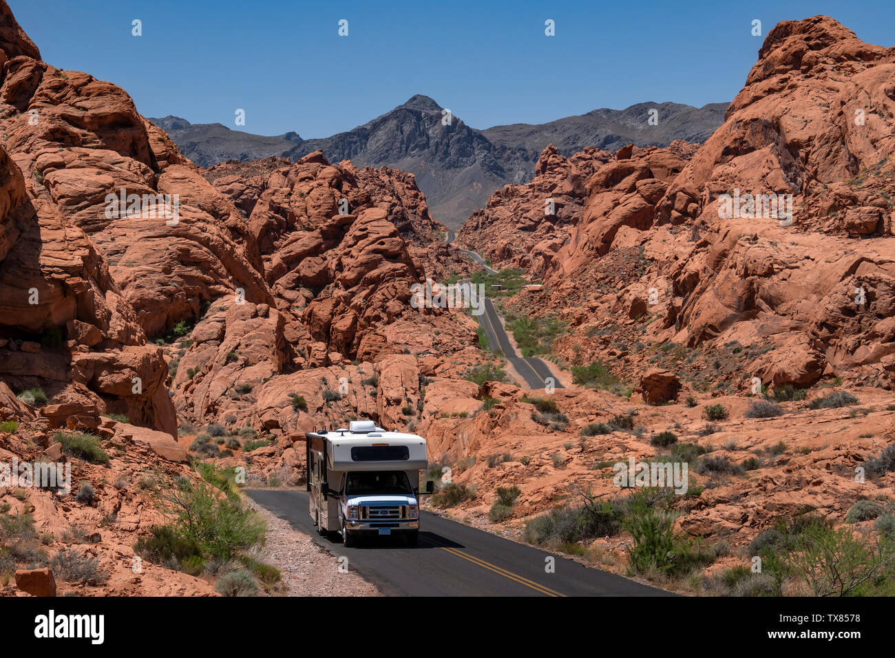 RV Vehicle or Camper Van driving the highway through the Valley of Fire State Park, Nevada, USA Stock Photo