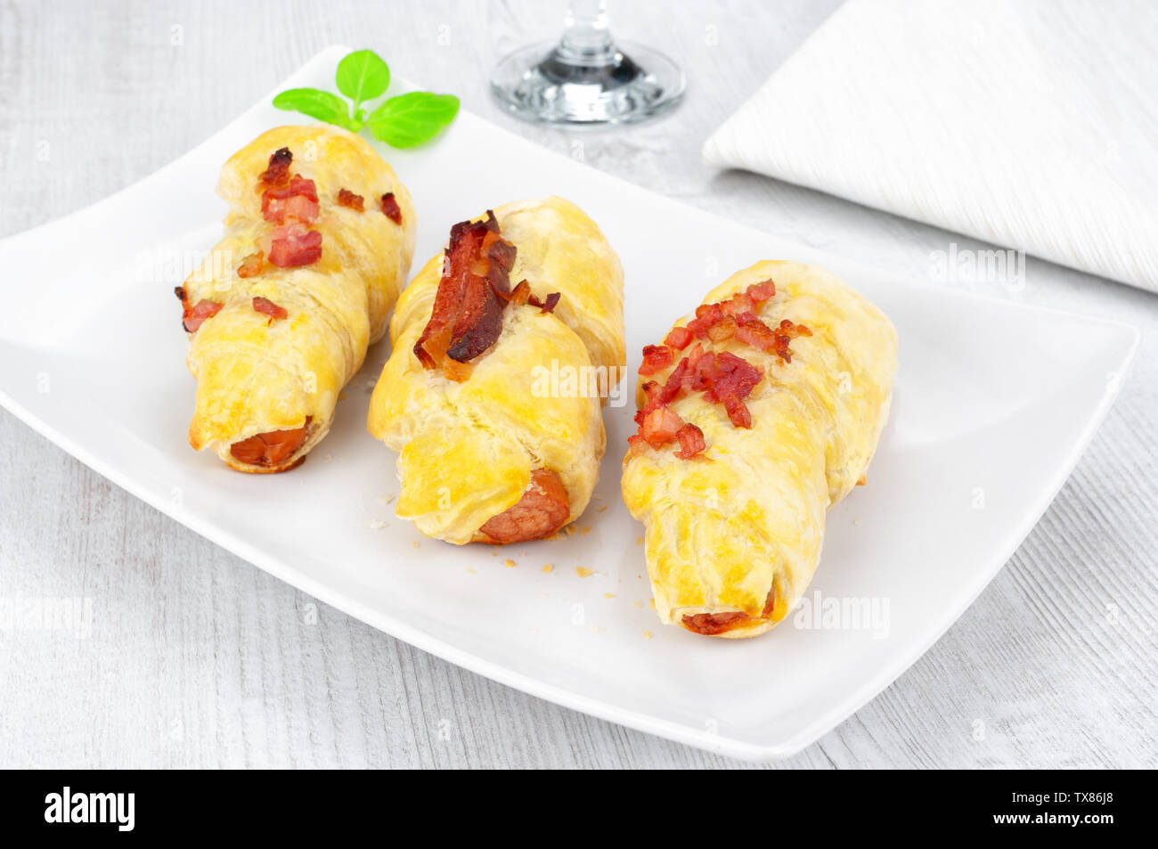 Puff pastry snacks with sausage and bacon Stock Photo Alamy