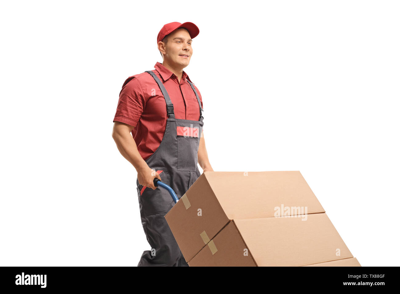 Male worker pushing a hand truck with boxes isolated on white background Stock Photo