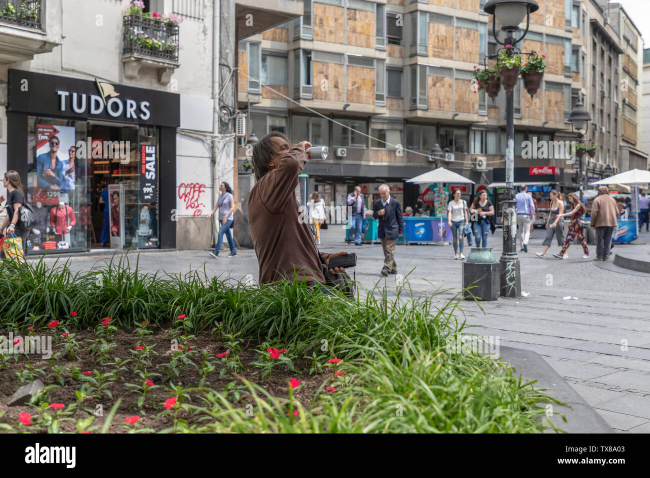 Belgrade, Serbia, June 6th 2019: Urban scene with man drinking beer from a can at Knez Mihailova Street Stock Photo