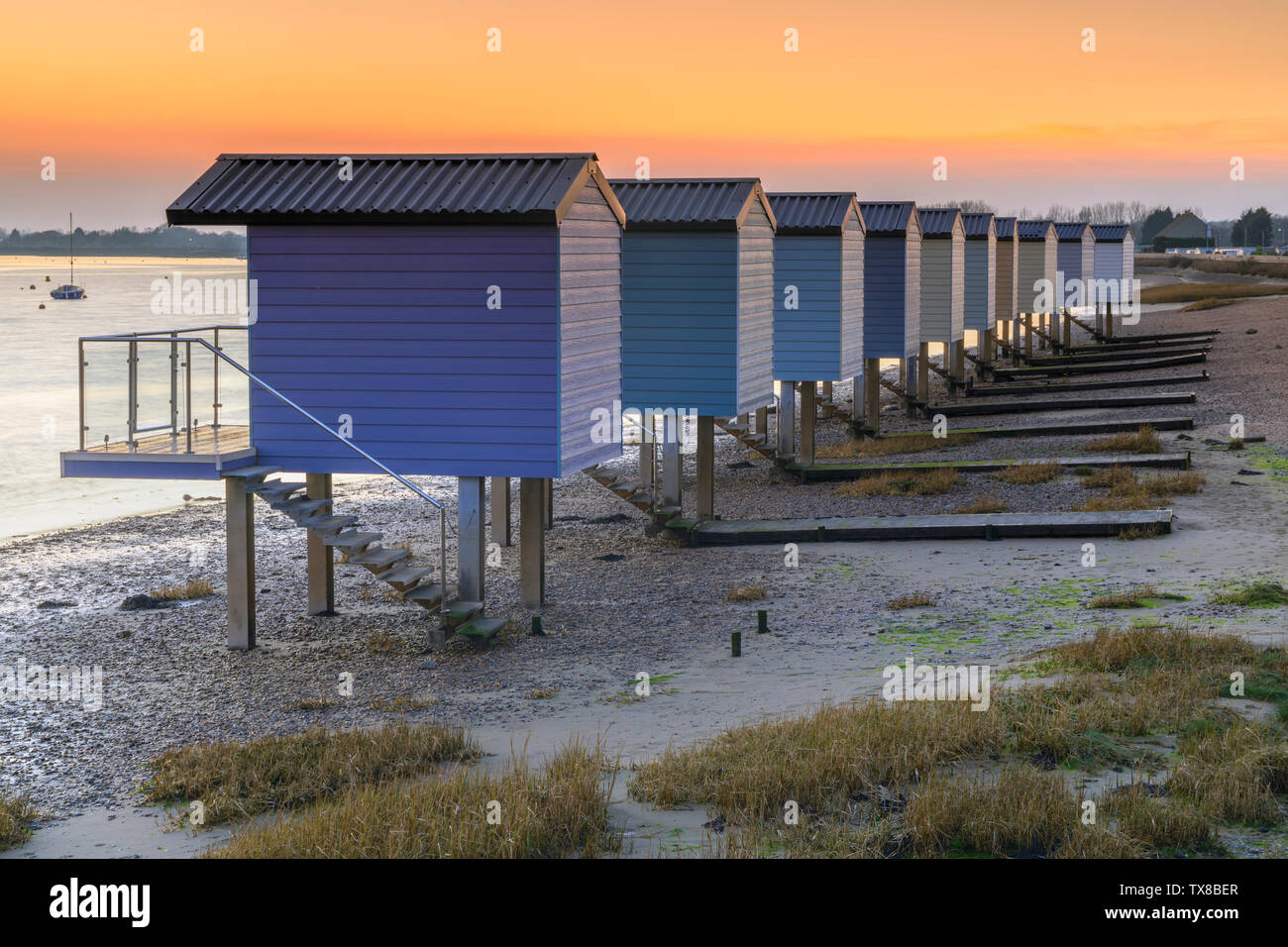 Sunset at Osea Beach Huts on the Blackwater Estuary in Essex. Stock Photo