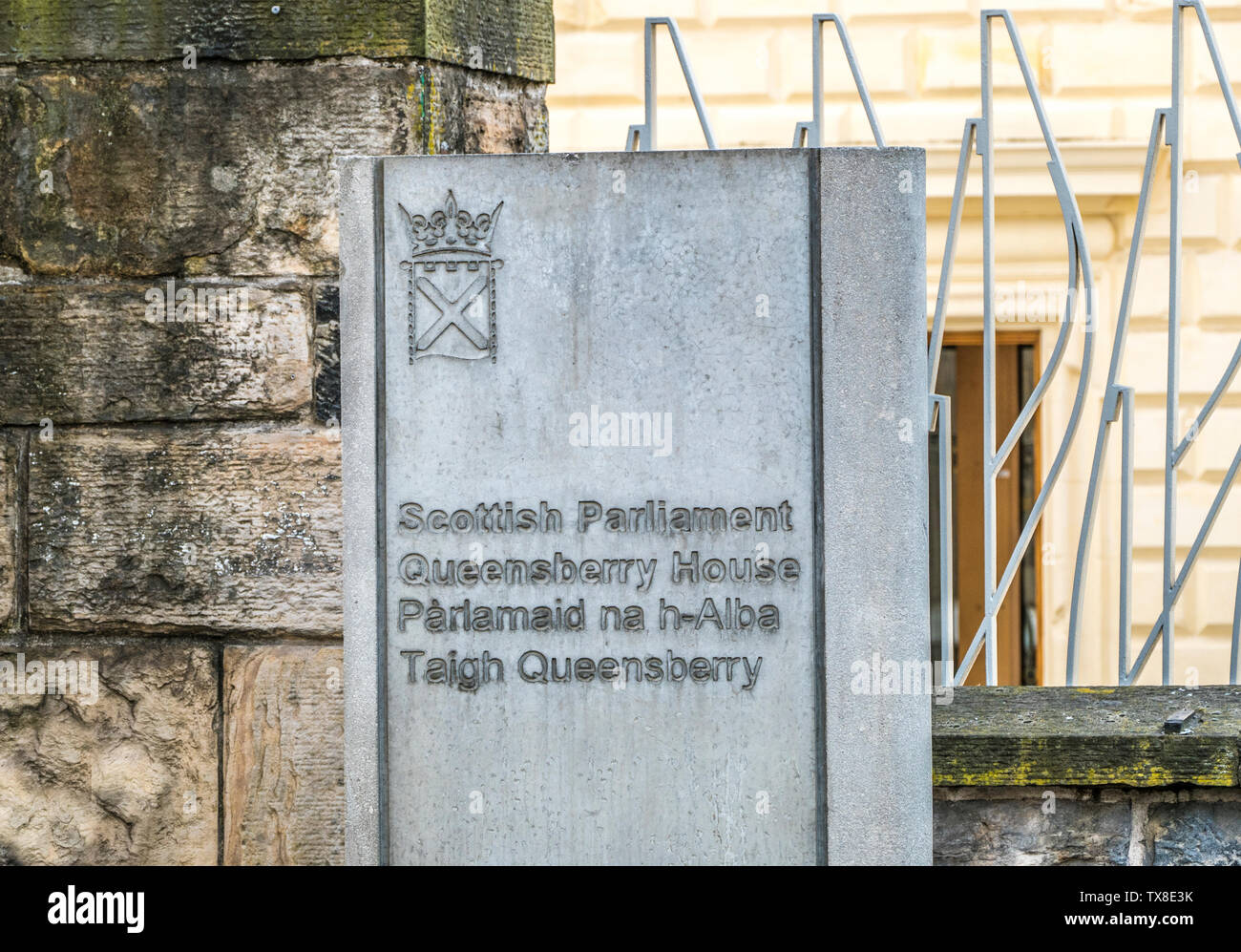 Stone sign outside Queensberry House, which is part of the Scottish Parliament complex. Canongate, the Royal Mile, Edinburgh, Scotland, UK. Stock Photo