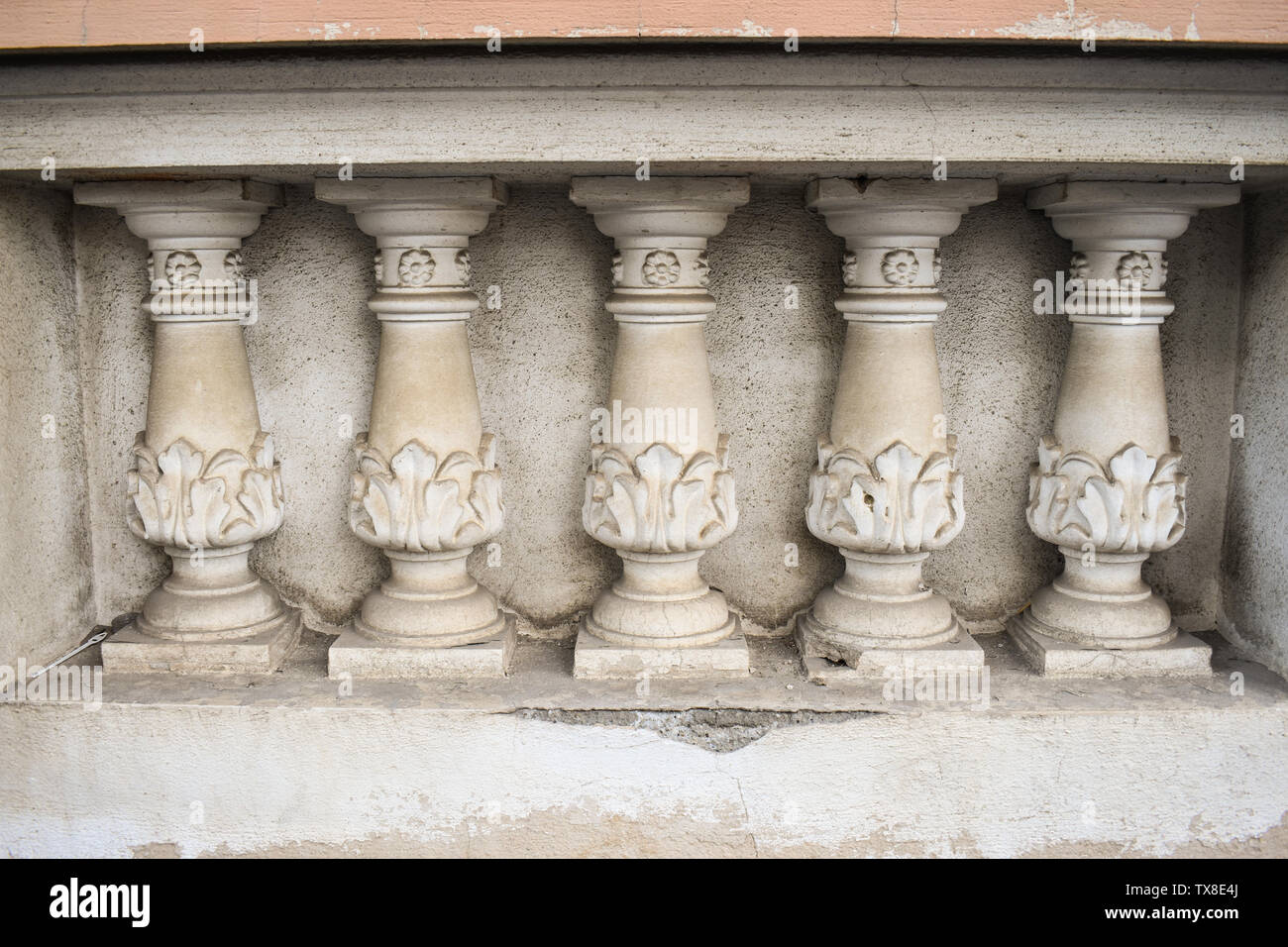 Neo classical architecture details on the old building. Stone sculpted pillars on the balcony facade. Stock Photo