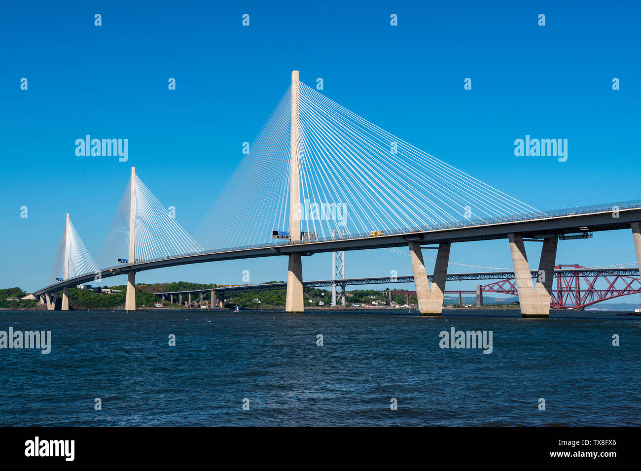 New Queensferry Crossing road bridge, with Forth Road Bridge and Forth Railway Bridge in background, viewed from South Queensferry, Scotland, UK Stock Photo