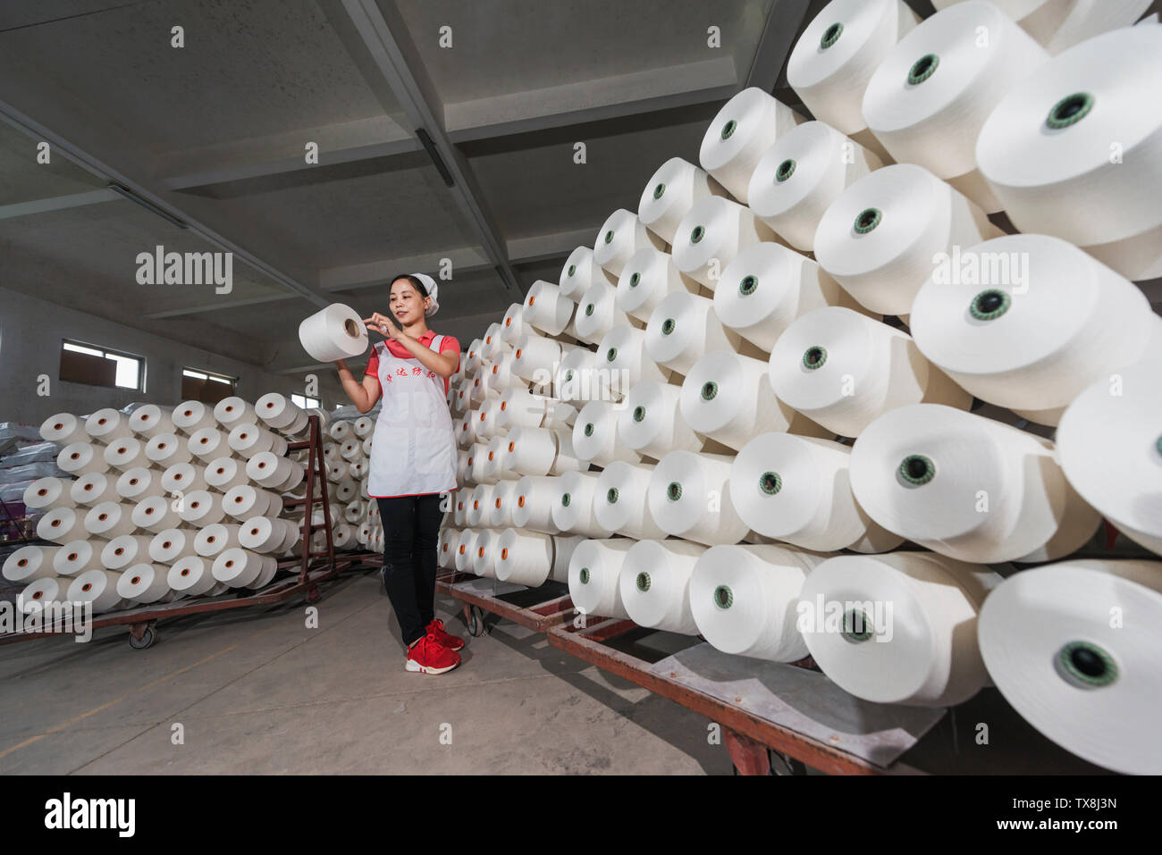 A woman in a textile factory. Stock Photo
