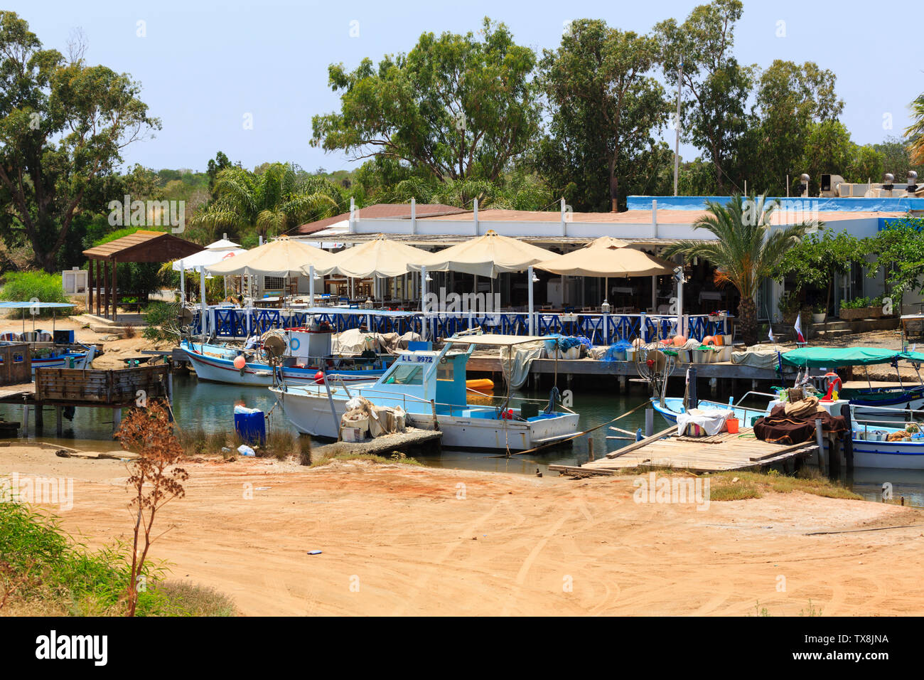Local fishing boats moored in Potamos Creek opposite the Potamos Fish restaurant, Liopetri, Cyprus. Jun 2019 Stock Photo