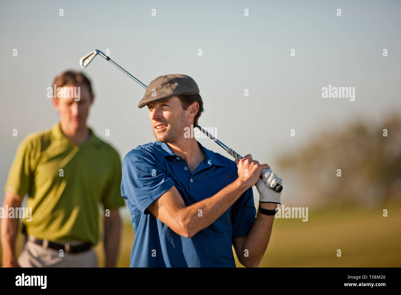 Smiling mid adult man playing golf. Stock Photo