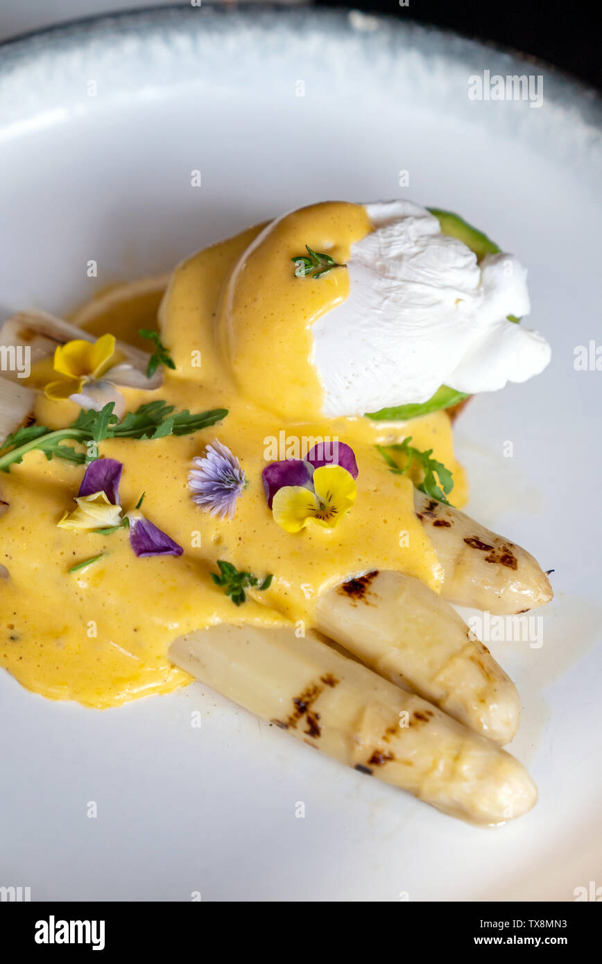 Gourmet Grilled White Asparagus With Poached Egg Serve With Hollandaise Savory Sauce Decorate With Edible Colorful Flowers Stock Photo Alamy