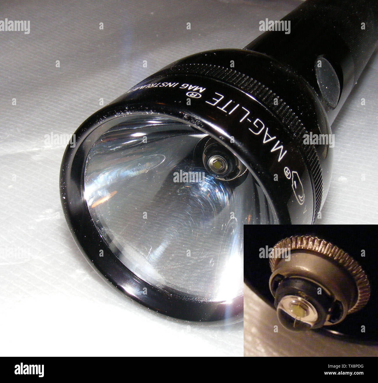 Detailed photograph of a Maglite 4-D flashlight with a 3-watt Luxeon LED  module installed. The inset in the lower right corner is a macro shot of  the LED module with the reflector