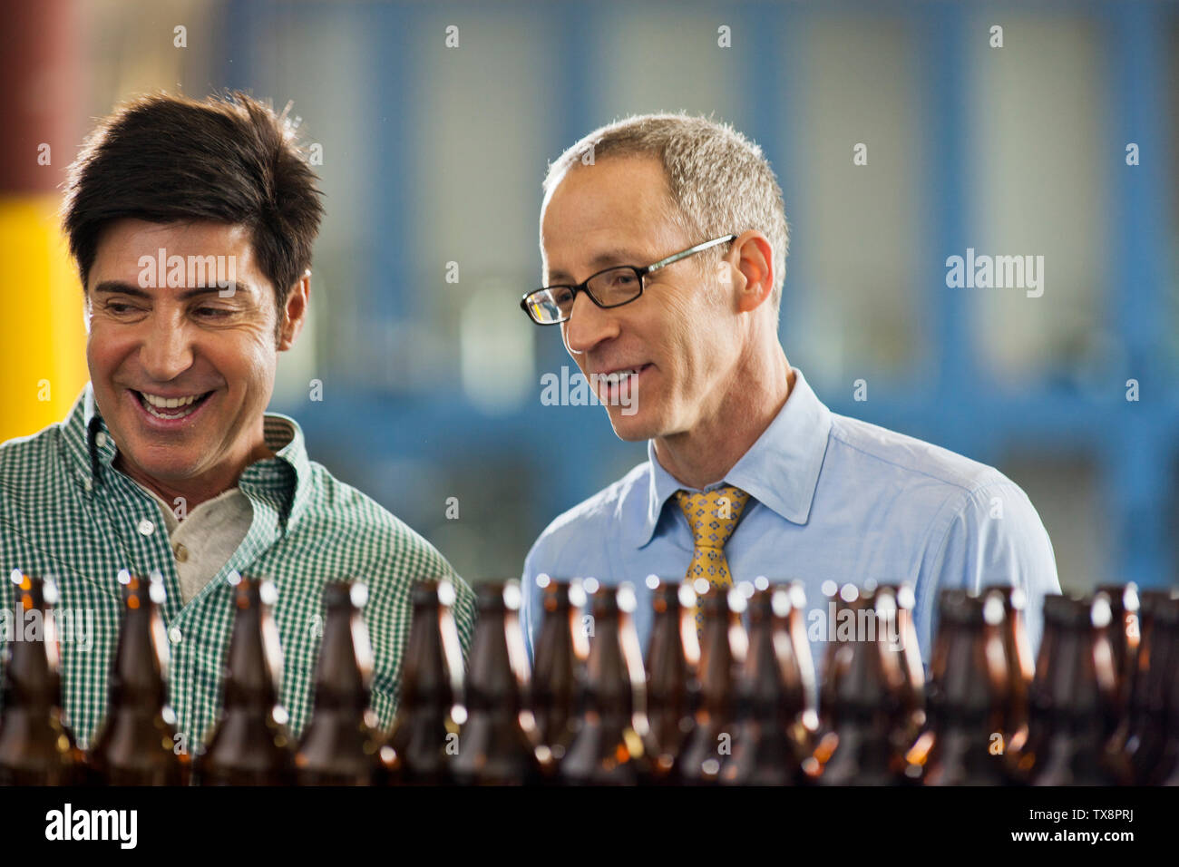 Two colleagues discussing work in a brewery. Stock Photo
